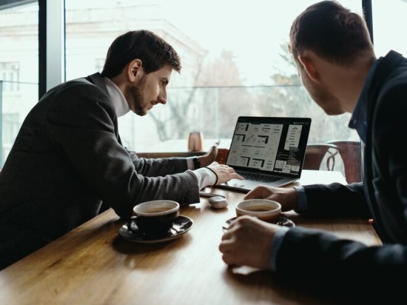two-young-businessman-having-successful-meeting-restaurant_158595-5245